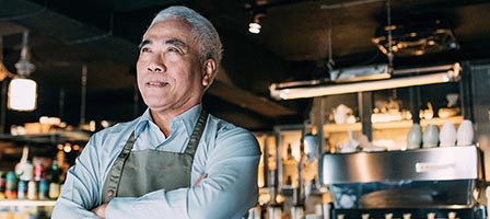 Cafe owner smiling confidently