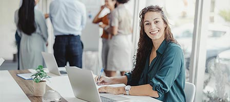 Smiling woman working on laptop