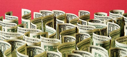 U.S. currency display against red surface