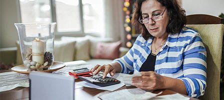 Lady using calculator at desk