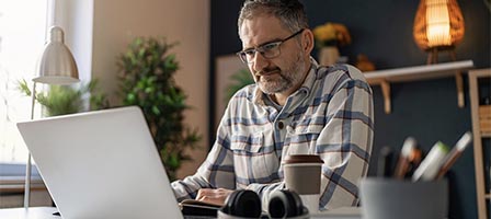 Mature man focused on computer screen