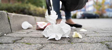 Trash scattered on cobblestone path