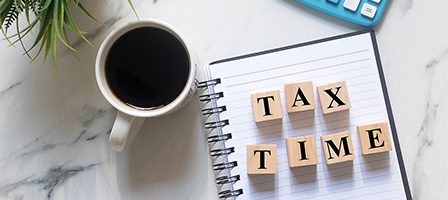 Coffee, calculator, and tax time blocks