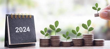 Coins with sprouts beside 2024 calendar