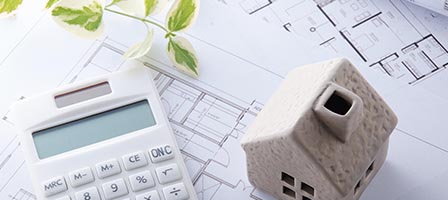Architectural plans with house model and calculator
