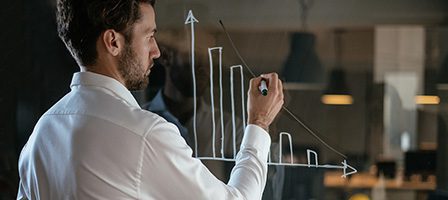 Male professional illustrating financial data trends