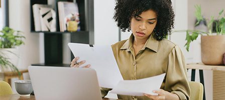 Person reviewing documents at a desk