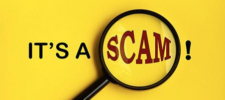 Scam warning with magnifying glass.