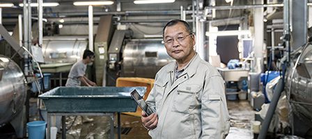 Factory worker holding tool in industrial setting