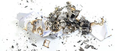Crumpled and charred paper remains