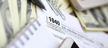 Tax form with pen and money