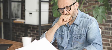 Individual analyzing paperwork indoors