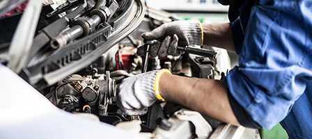 Mechanic working on a car engine