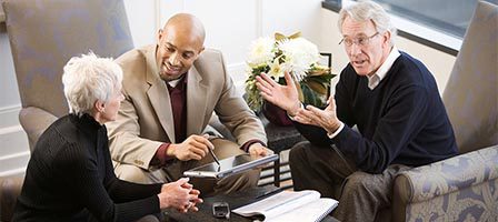 Colleagues engaged in conversation around table