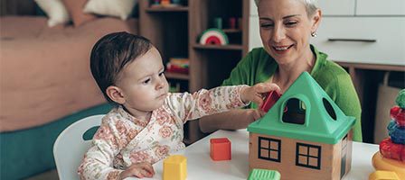 Toddler exploring colorful building blocks