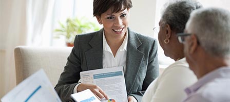 Businesswoman presenting documents to clients