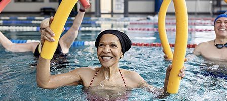 Woman enjoying water aerobics class