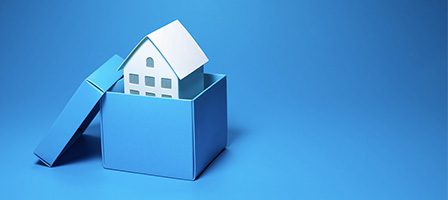 House model inside blue gift box