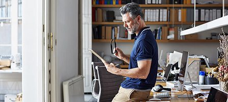 Man reading document in office
