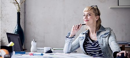 Person pondering ideas at work desk