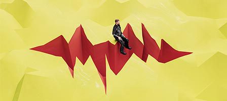 Person sitting on abstract red structure