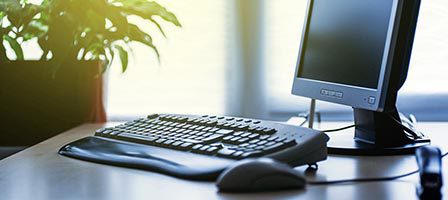 Computer monitor and keyboard on desk