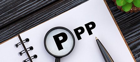 Magnifying glass over letter P on paper
