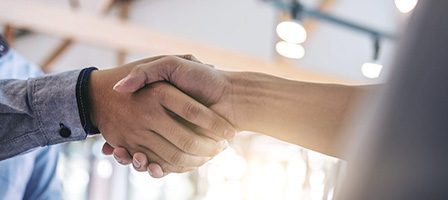 Business handshake in an office setting