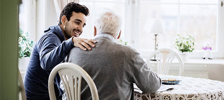 Younger man with arm around older man