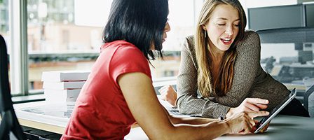Two women collaborating in office