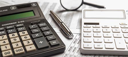 Calculators and pen on financial documents