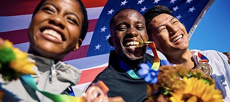 Athletes celebrating with medals and flowers