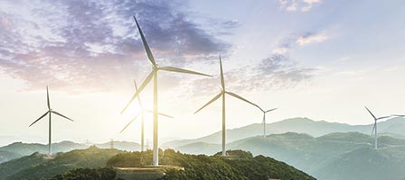 Scenic view of wind turbines and hills