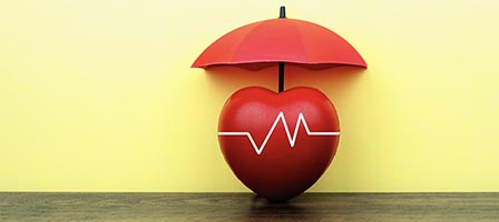 Red heart shielded by umbrella