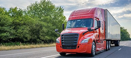 Large red truck in motion