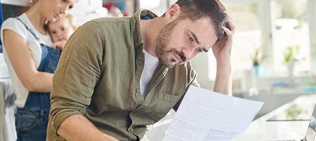 Man reading document, looking concerned