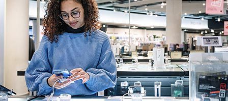 Woman shopping for smartphones indoors