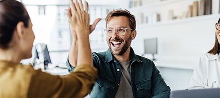 Team members sharing a high-five moment