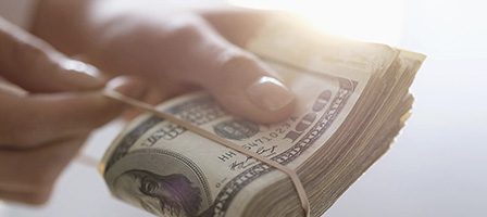 Person gripping a money wad