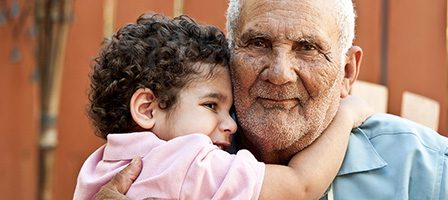 Grandfather and grandson embrace warmly