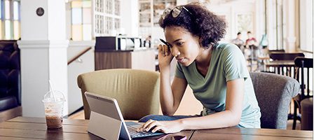 Woman working on laptop in cafe