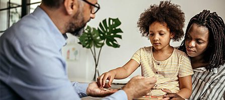 Therapist guiding family during session