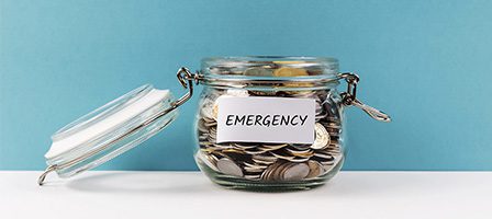 Emergency fund jar filled with coins