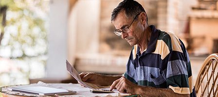 Senior working on paperwork indoors