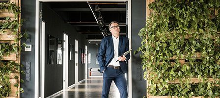 Businessman with clipboard in hallway