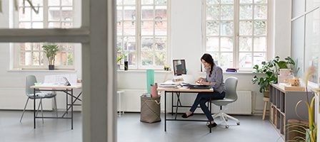 Woman focused on work in spacious office