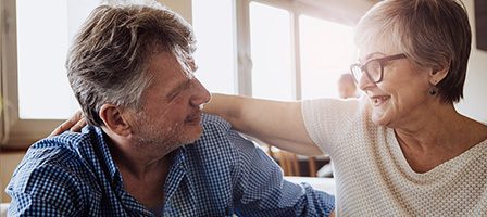 Elderly couple smiling at each other