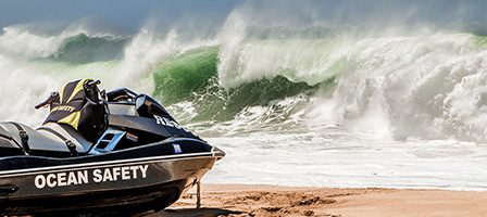 Jet ski on beach with crashing waves