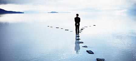 Solitary figure on reflective water stones