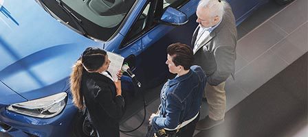 Overhead view of car sale conversation